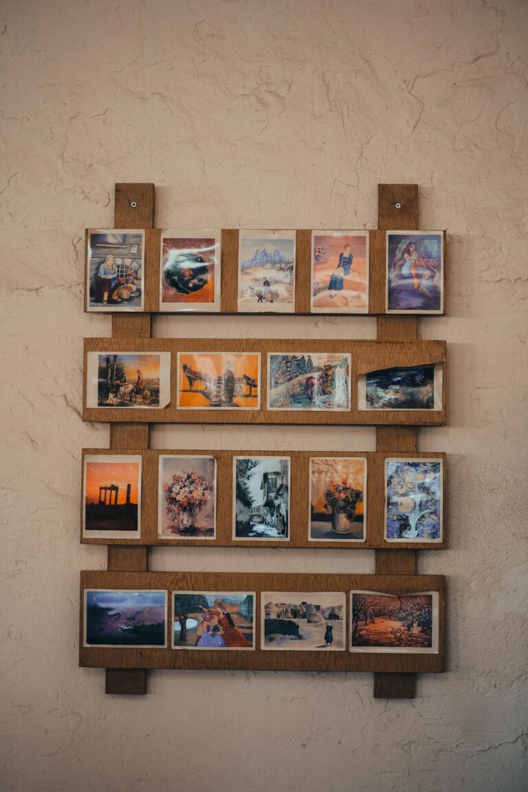 A collection of framed art prints and photographs beautifully displayed on a rustic wall.