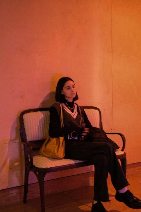 Relaxed woman sitting on a sofa in a warm, dimly lit room in Istanbul.